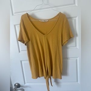 Mustard yellow shirt with tie at the bottom